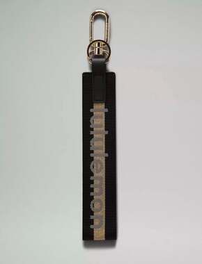 Lululemon Never Lost Keychain Wordmark Black and Gold